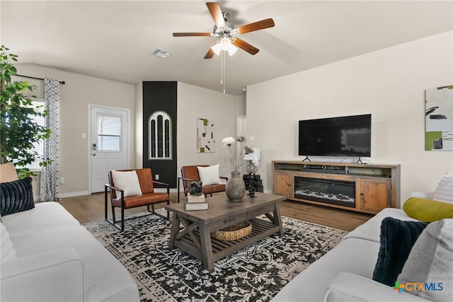 living room with hardwood / wood-style flooring and ceiling fan