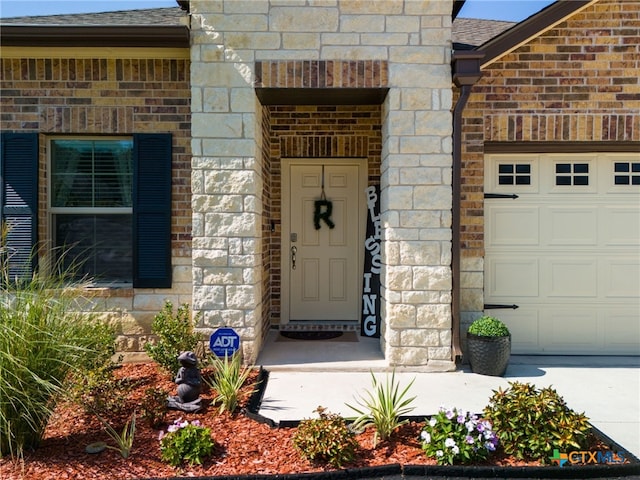 doorway to property featuring a garage