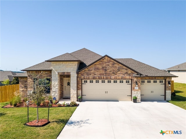 view of front of house with a garage and a front yard