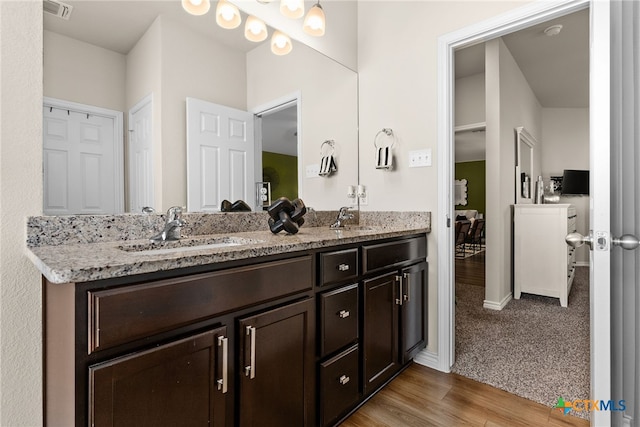 bathroom with vanity and hardwood / wood-style flooring