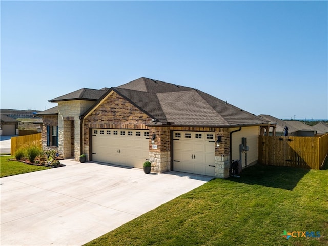 view of front of home featuring a garage and a front yard