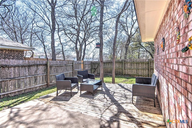 view of patio with a deck and a fenced backyard