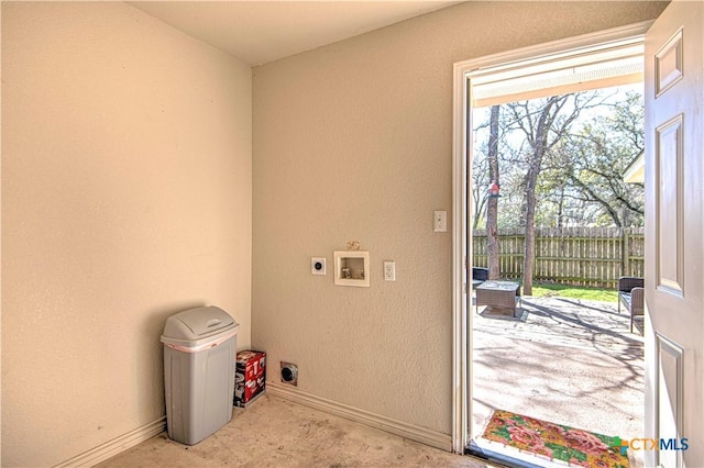 laundry area with a textured wall, hookup for a washing machine, hookup for an electric dryer, laundry area, and baseboards