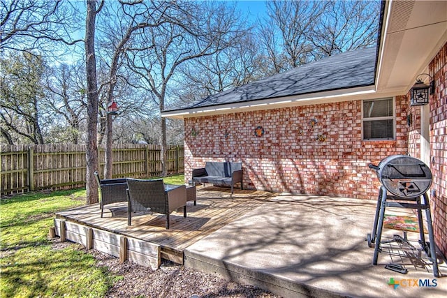 view of patio featuring fence and a deck