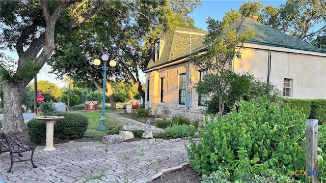 400 S Main St, Belton, TX 76513 - view of property exterior with stucco siding, a shingled roof, and a chimney