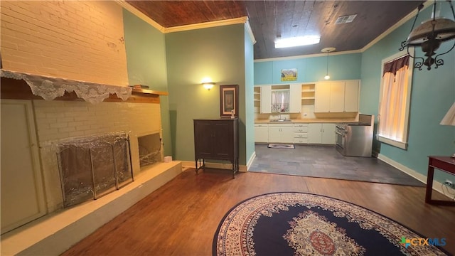 400 S Main St, Belton, TX 76513 - bathroom featuring ornamental molding, a fireplace with raised hearth, wood finished floors, brick wall, and wood ceiling