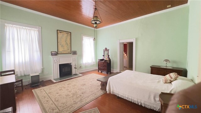 400 S Main St, Belton, TX 76513 - bedroom with crown molding, a fireplace, and wood finished floors