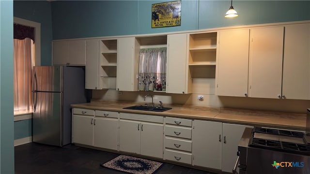 400 S Main St, Belton, TX 76513 - kitchen with open shelves, freestanding refrigerator, light countertops, and white cabinets