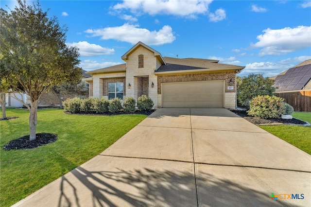 view of front of home featuring brick siding, a front lawn, concrete driveway, stone siding, and an attached garage