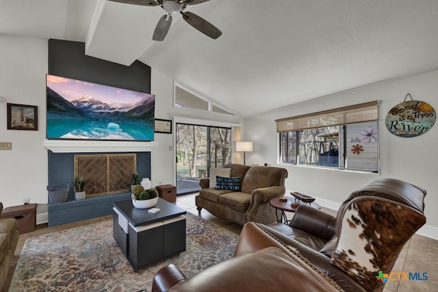 living room with high vaulted ceiling, a fireplace with raised hearth, tile patterned flooring, baseboards, and ceiling fan