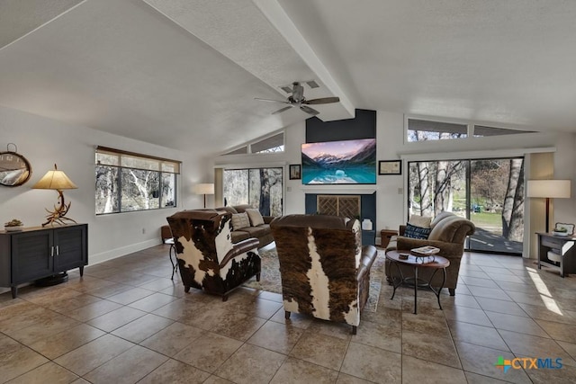 tiled living room featuring ceiling fan, a fireplace, lofted ceiling with beams, and baseboards