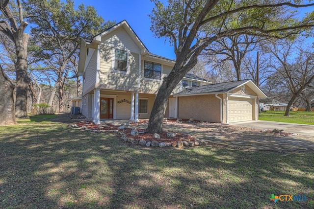 traditional-style house with a garage and a front lawn