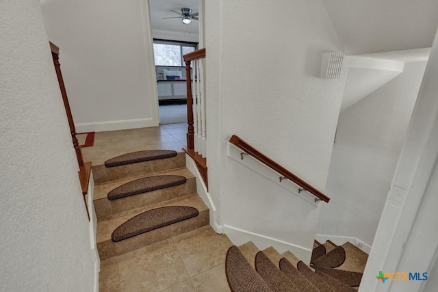 stairway featuring tile patterned floors, baseboards, and ceiling fan