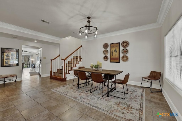 dining space featuring visible vents, baseboards, ornamental molding, and stairs