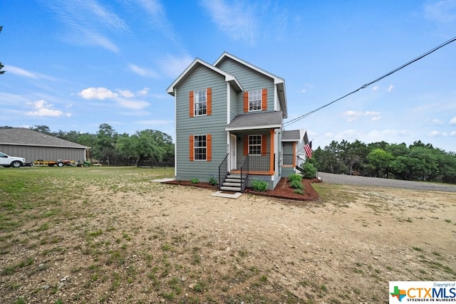 view of front property with covered porch and a front lawn