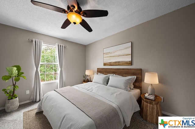 bedroom with ceiling fan, a textured ceiling, and carpet