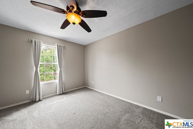 spare room featuring ceiling fan, a textured ceiling, and carpet floors