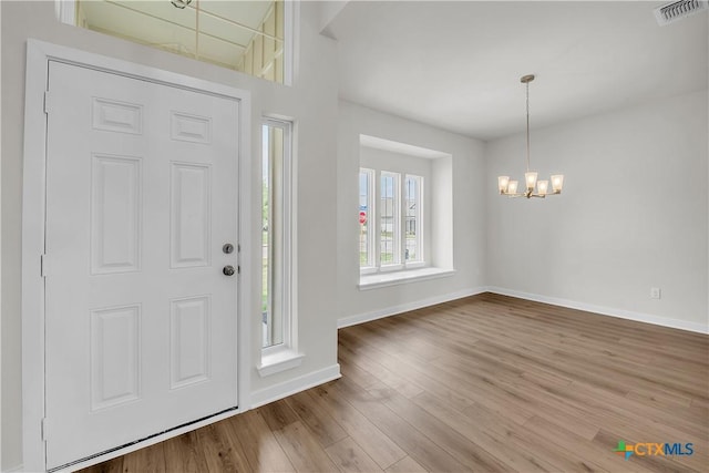 1531 Hillside Dr, Temple, TX 76502 - foyer with a chandelier, baseboards, and wood finished floors