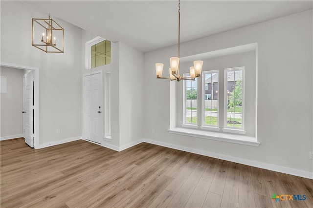 1531 Hillside Dr, Temple, TX 76502 - unfurnished dining area featuring a chandelier, wood finished floors, and baseboards