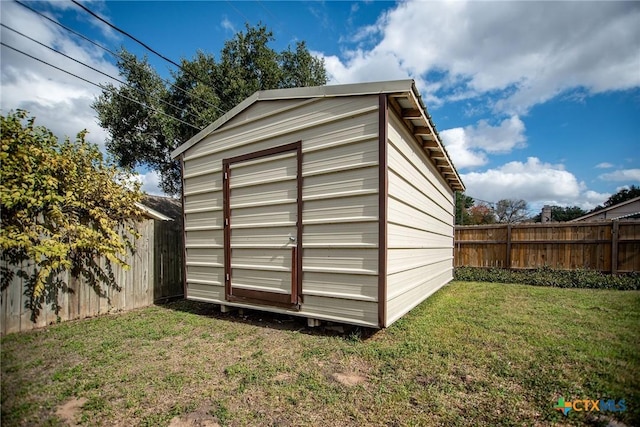 view of outbuilding featuring a lawn