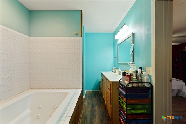 725 Baffin Dr, Port Mansfield, TX 78598 - ensuite bathroom with wood finished floors, a jetted tub, and vanity