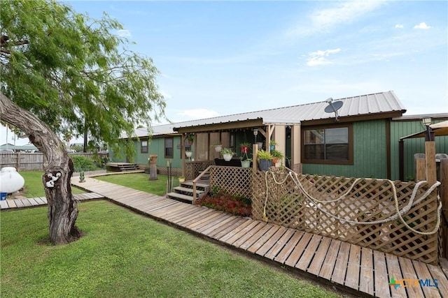 725 Baffin Dr, Port Mansfield, TX 78598 - rear view of house with a deck and metal roof