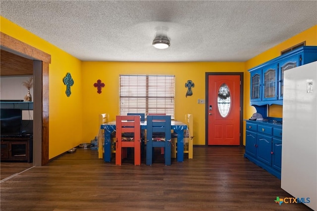 725 Baffin Dr, Port Mansfield, TX 78598 - dining space with dark wood-type flooring and a textured ceiling