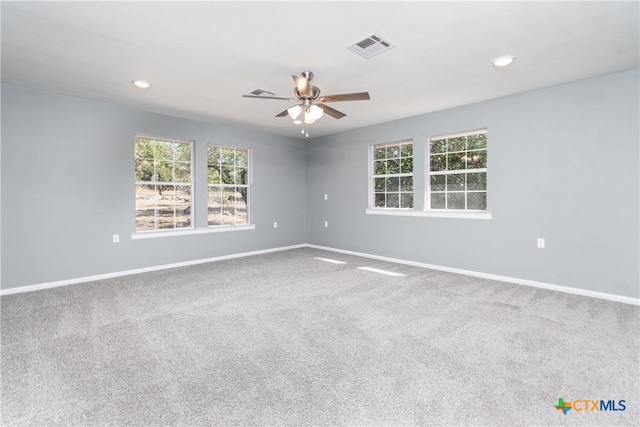 empty room with ceiling fan and carpet floors