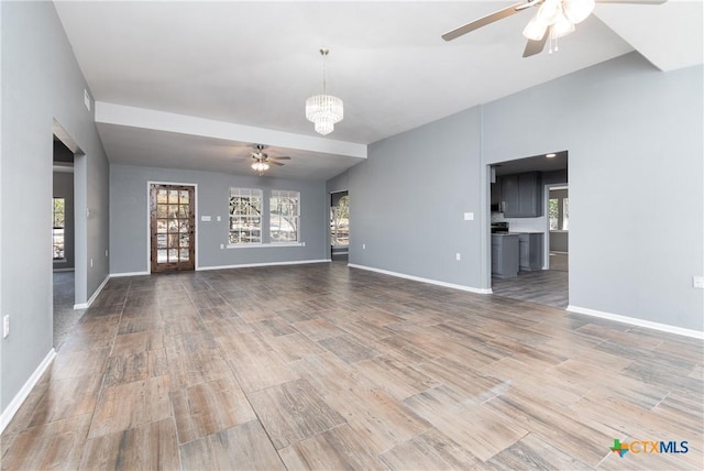 13989 Indian Bluff Rd, Temple, TX 76502 - unfurnished living room featuring a ceiling fan, wood finished floors, and a chandelier