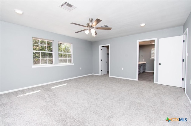 13989 Indian Bluff Rd, Temple, TX 76502 - unfurnished bedroom with carpet, connected bathroom, a spacious closet, a ceiling fan, and recessed lighting