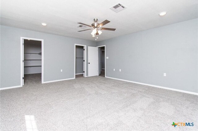 13989 Indian Bluff Rd, Temple, TX 76502 - unfurnished bedroom with carpet, a spacious closet, recessed lighting, and ceiling fan