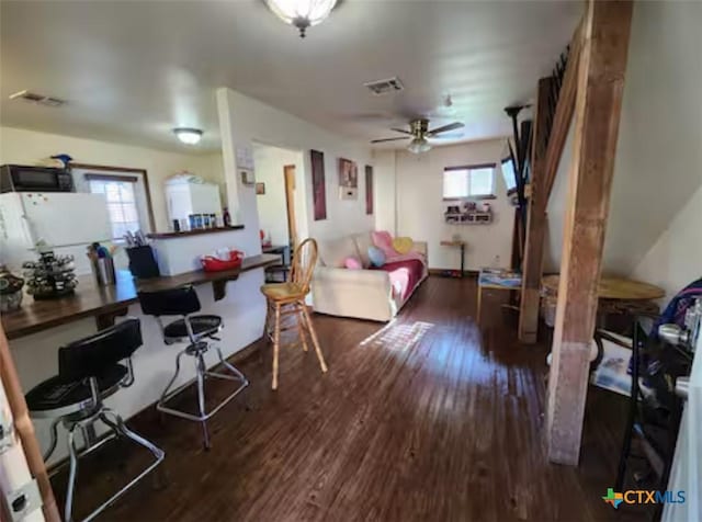 1123 N Beal St, Belton, TX 76513 - living room with wood finished floors, a ceiling fan, and a desk