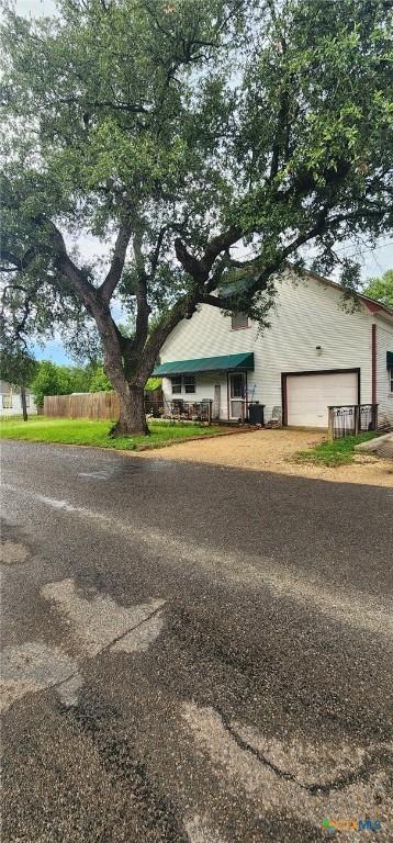 1123 N Beal St, Belton, TX 76513 - view of front of property with dirt driveway and an attached garage