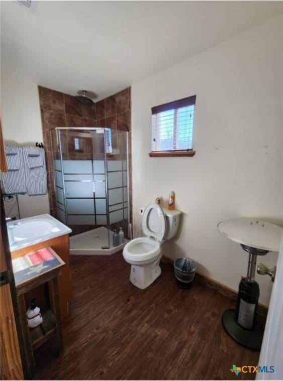 1123 N Beal St, Belton, TX 76513 - bathroom featuring wood finished floors, a stall shower, and vanity