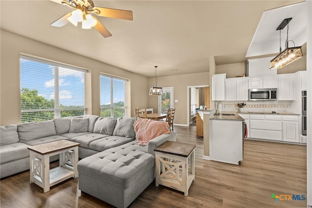 1205 Bowen Ave, Copperas Cove, TX 76522 - living area with wood finished floors, a ceiling fan, and baseboards