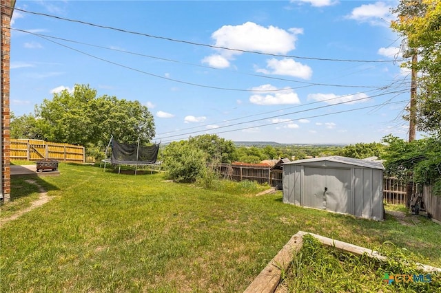 1205 Bowen Ave, Copperas Cove, TX 76522 - view of yard featuring a storage shed, an outdoor fire pit, an outbuilding, and a trampoline