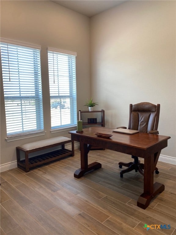 office featuring baseboards and wood finished floors