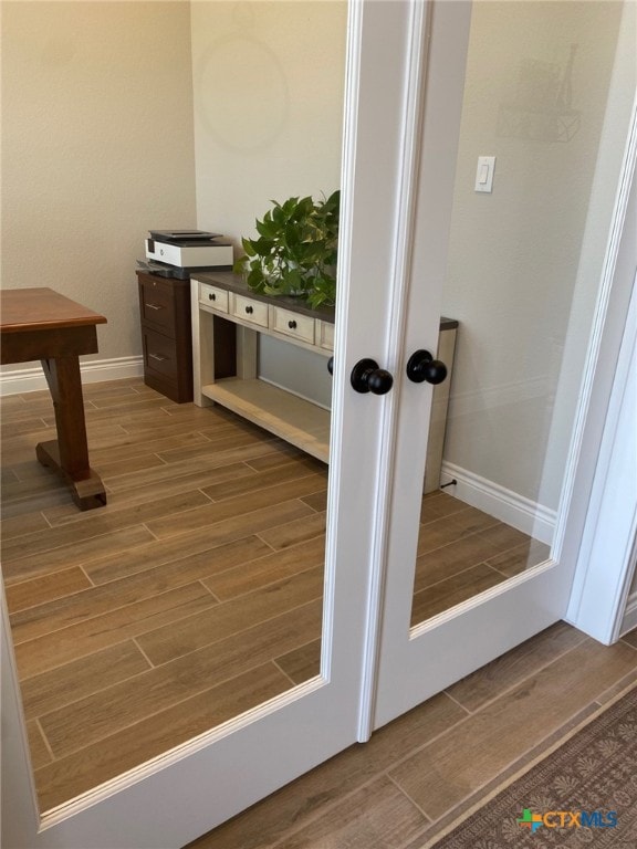 details featuring baseboards and wood tiled floor