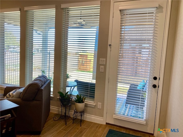 interior space with baseboards and wood tiled floor