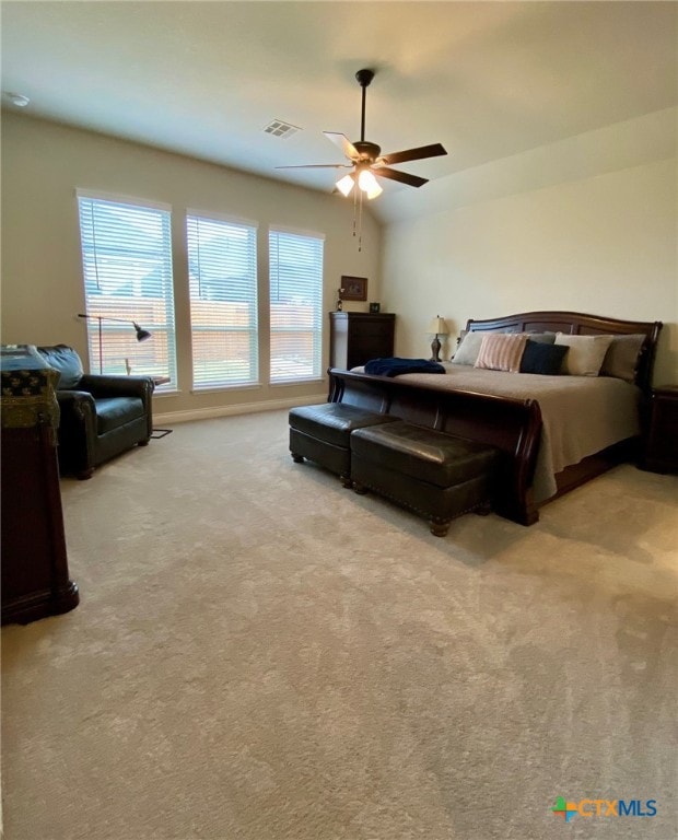 bedroom with visible vents, carpet flooring, lofted ceiling, and ceiling fan