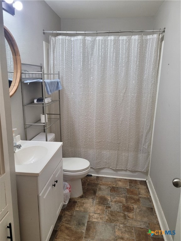 full bathroom featuring toilet, vanity, and shower / bath combination with curtain