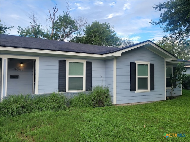 view of home's exterior with a yard