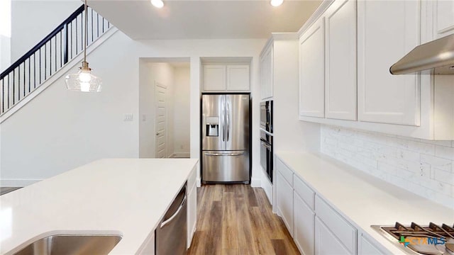 1822 Nettletree Rd, New Braunfels, TX 78132 - kitchen featuring white cabinets, light countertops, stainless steel appliances, and wood finished floors