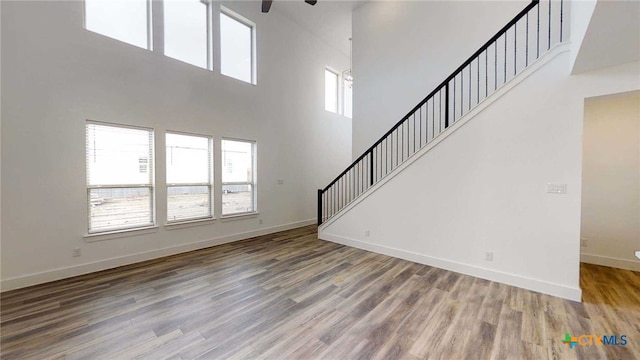 1822 Nettletree Rd, New Braunfels, TX 78132 - unfurnished living room with wood finished floors, baseboards, stairway, and ceiling fan