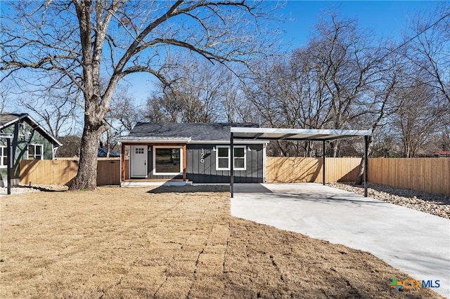 back of house with a carport