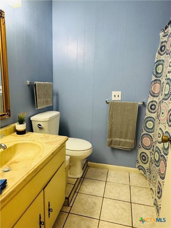 bathroom featuring tile patterned flooring, vanity, and toilet