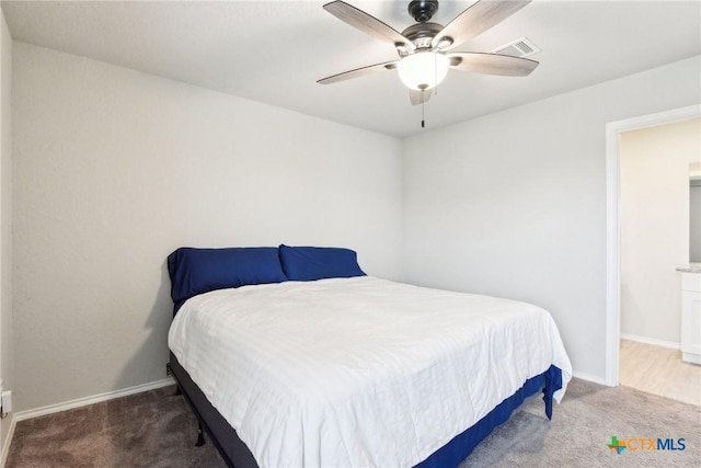 carpeted bedroom featuring visible vents, baseboards, and a ceiling fan