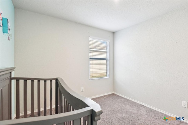 unfurnished bedroom featuring carpet flooring and baseboards