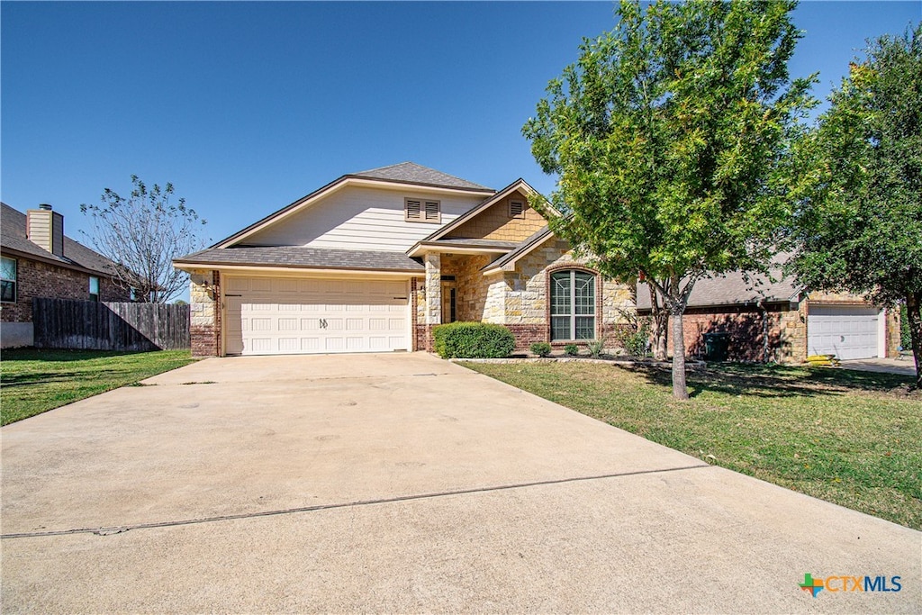 view of front of home featuring a garage and a front yard