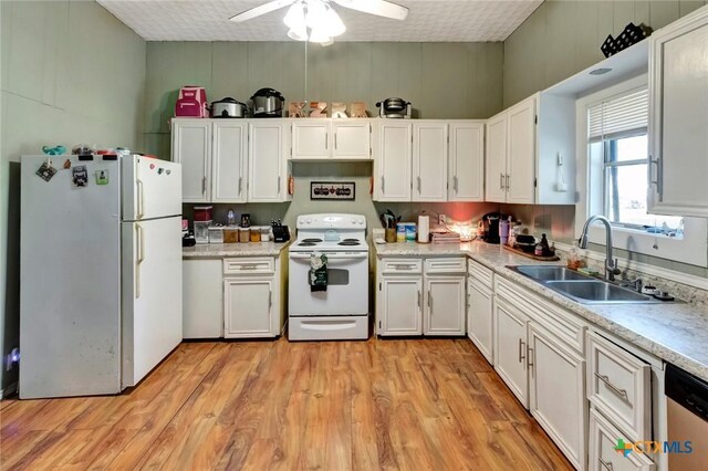 205 S Valley St, Cuero, TX 77954 - kitchen featuring white appliances, a sink, white cabinetry, a ceiling fan, and light countertops